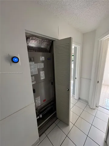 a hallway with cabinets and wooden floor