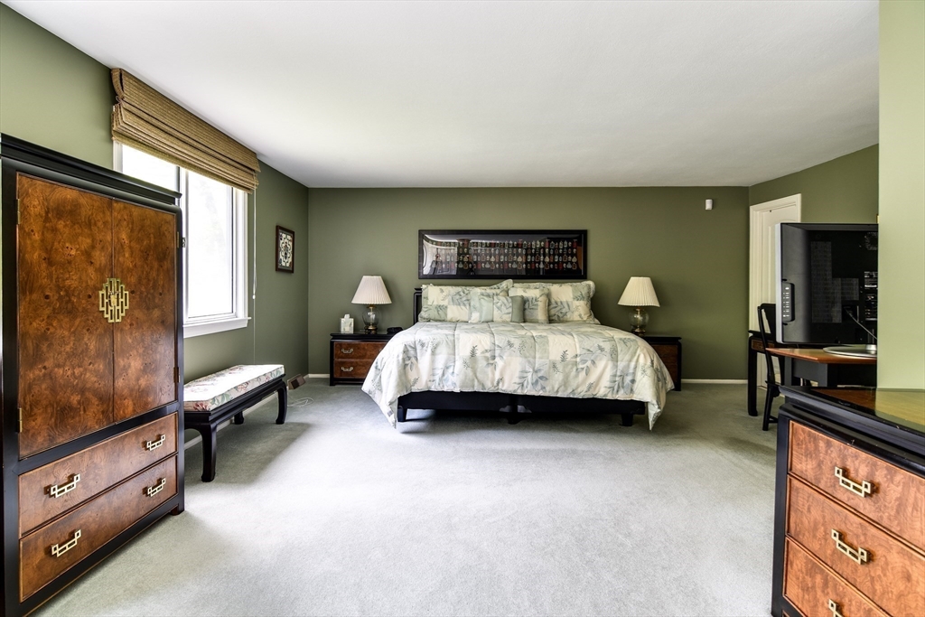 38 Stagecoach Drive Ashland, MA 01721 - Photo 24 of 29 a bedroom with a bed and a dresser with mirror