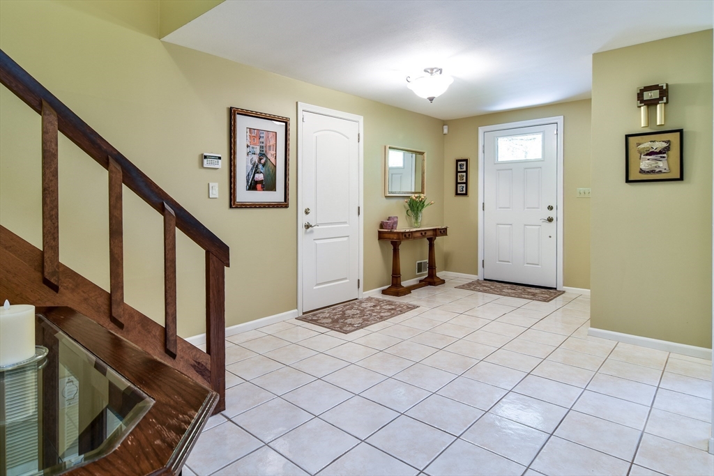38 Stagecoach Drive Ashland, MA 01721 - Photo 5 of 29 a bedroom with a bed and a lamp on dresser