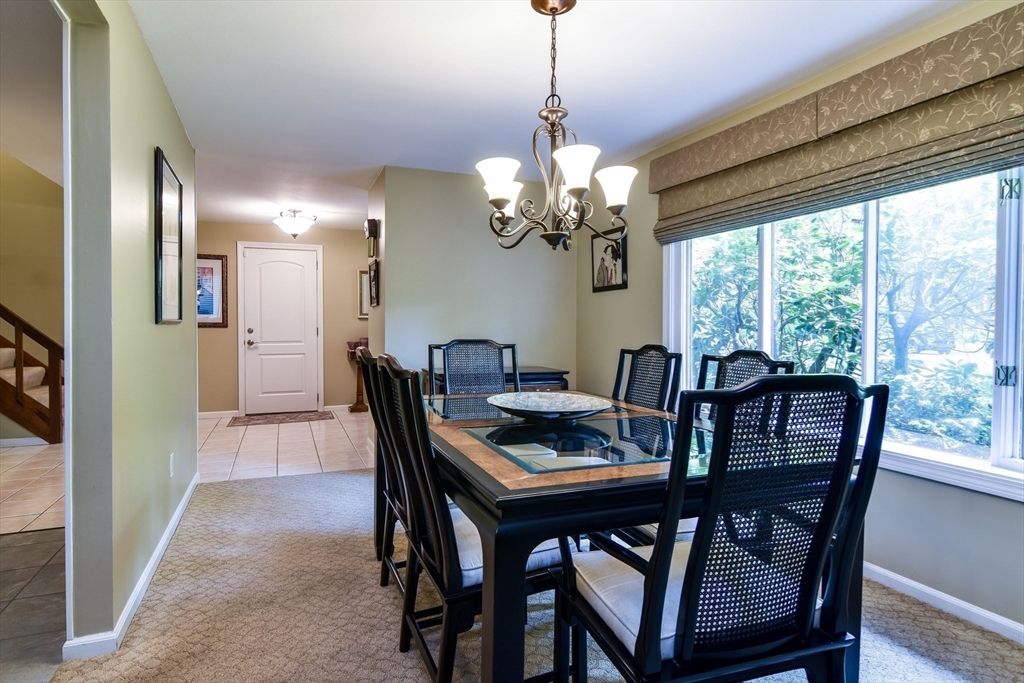 38 Stagecoach Drive Ashland, MA 01721 - Photo 8 of 29 a view of a dining room with furniture a chandelier and wooden floor