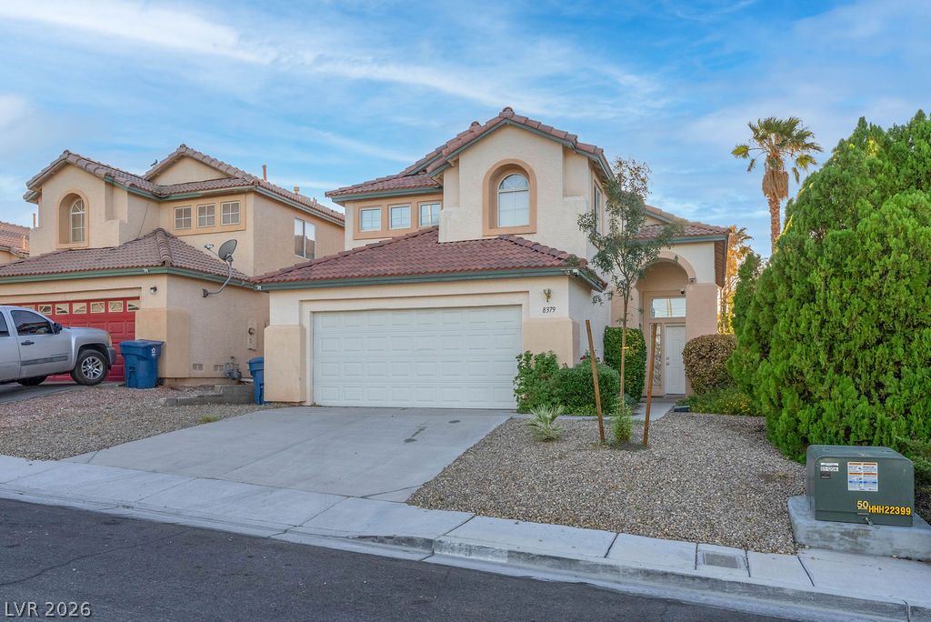 8379 Rockefeller Street Las Vegas, NV 89123 - Photo 35 of 36 Spanish tile roofing and classic stucco siding define this multi-level suburban residence.