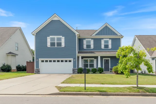 a front view of a house with a garden
