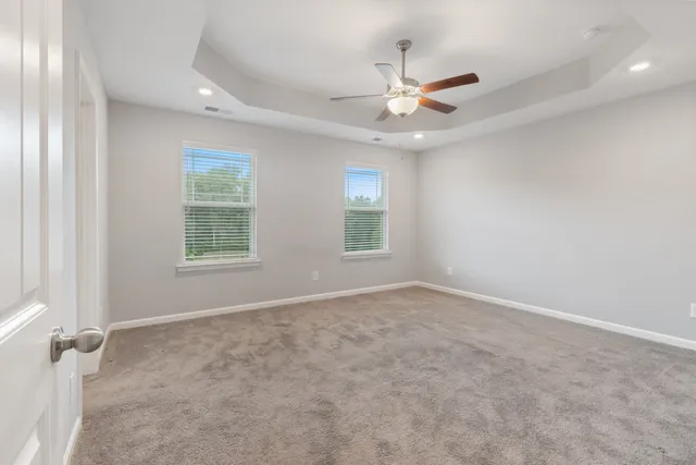 an empty room with closet and a chandelier fan