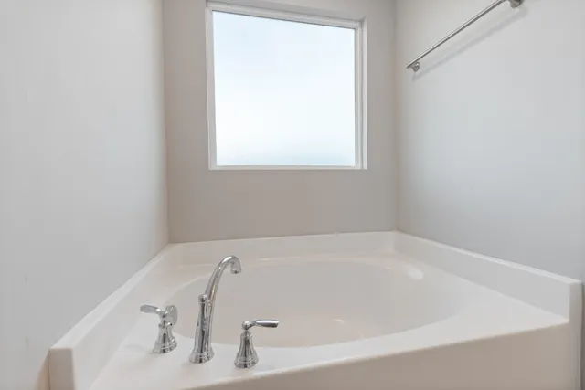 a bathroom with a double vanity sink toilet and mirror