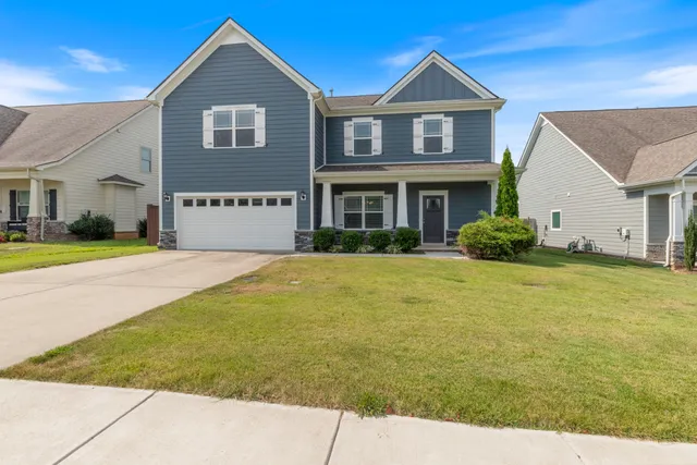 a front view of a house with garden