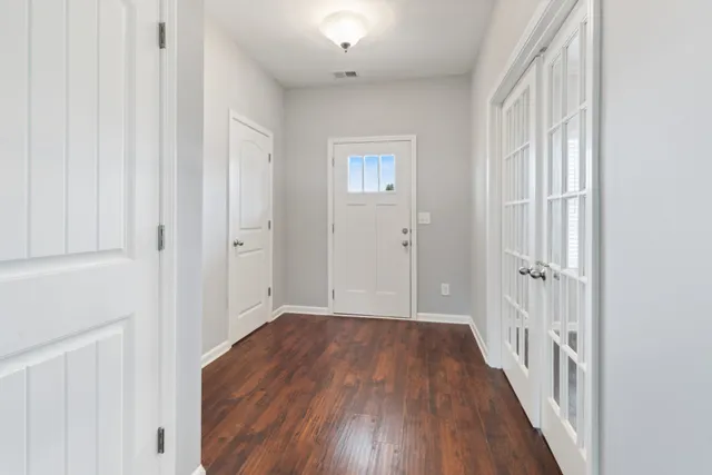 a view of a hallway with wooden floor