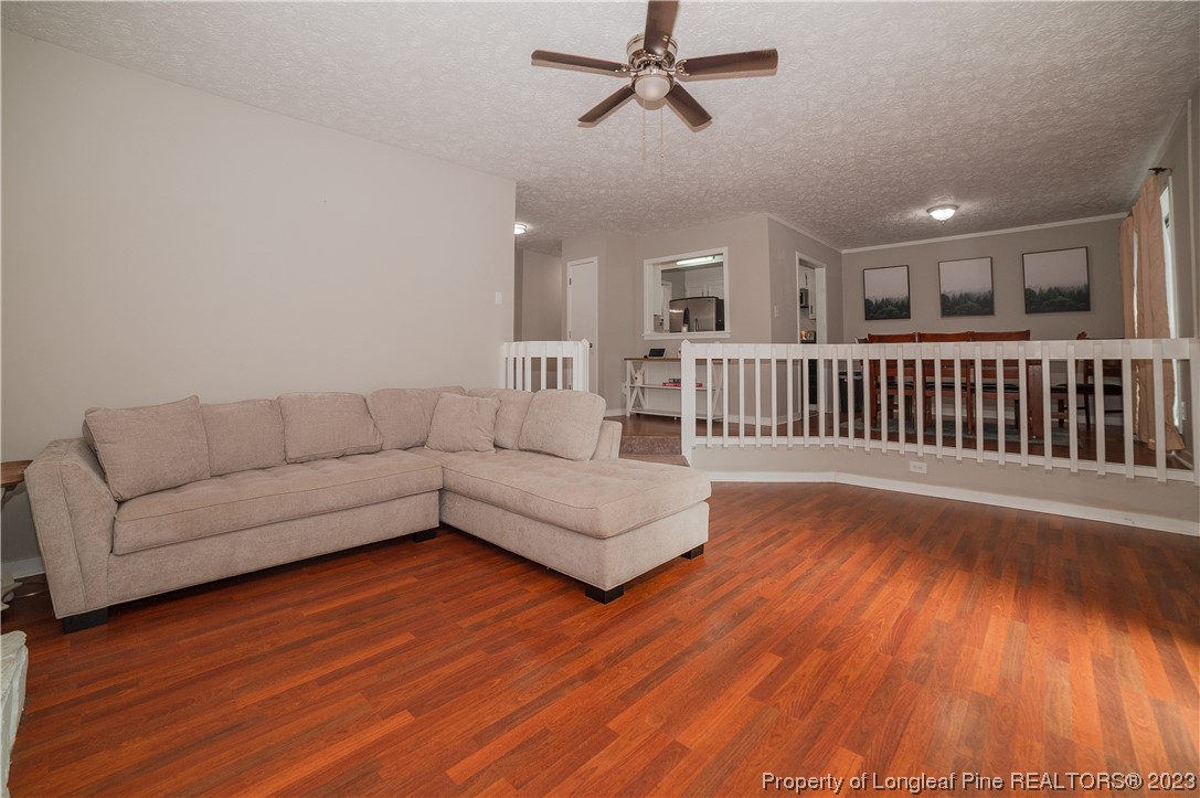 6005 Dalton Road Fayetteville, NC 28314 - Photo 13 of 44 a living room with furniture and a wooden floor