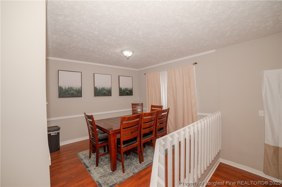 6005 Dalton Road Fayetteville, NC 28314 - Photo 14 of 44 a view of a dining room with furniture and wooden floor