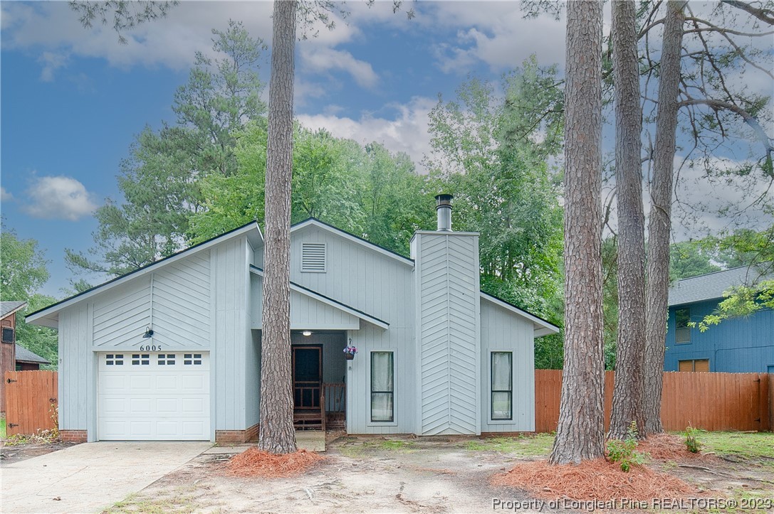 6005 Dalton Road Fayetteville, NC 28314 - Photo 2 of 44 a view of a white house with a large tree and wooden fence