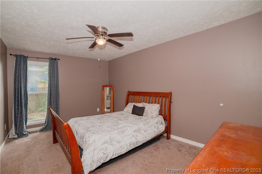 6005 Dalton Road Fayetteville, NC 28314 - Photo 29 of 44 a bedroom with a bed and ceiling fan