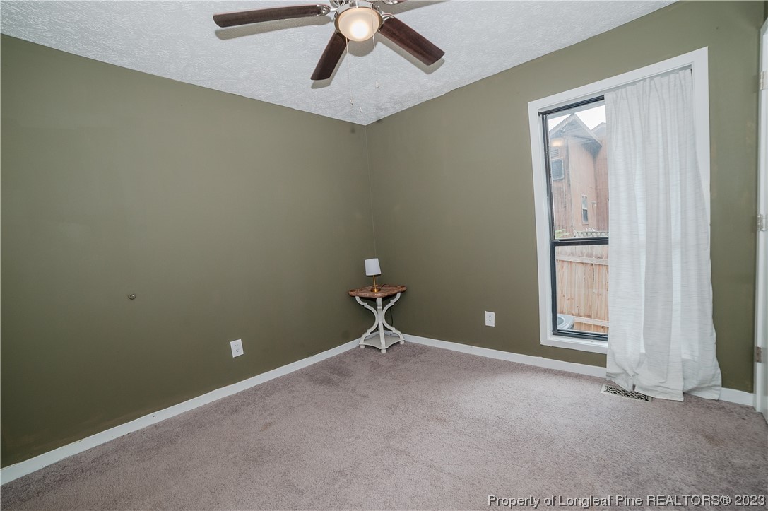 6005 Dalton Road Fayetteville, NC 28314 - Photo 38 of 44 a room with ceiling fan and window