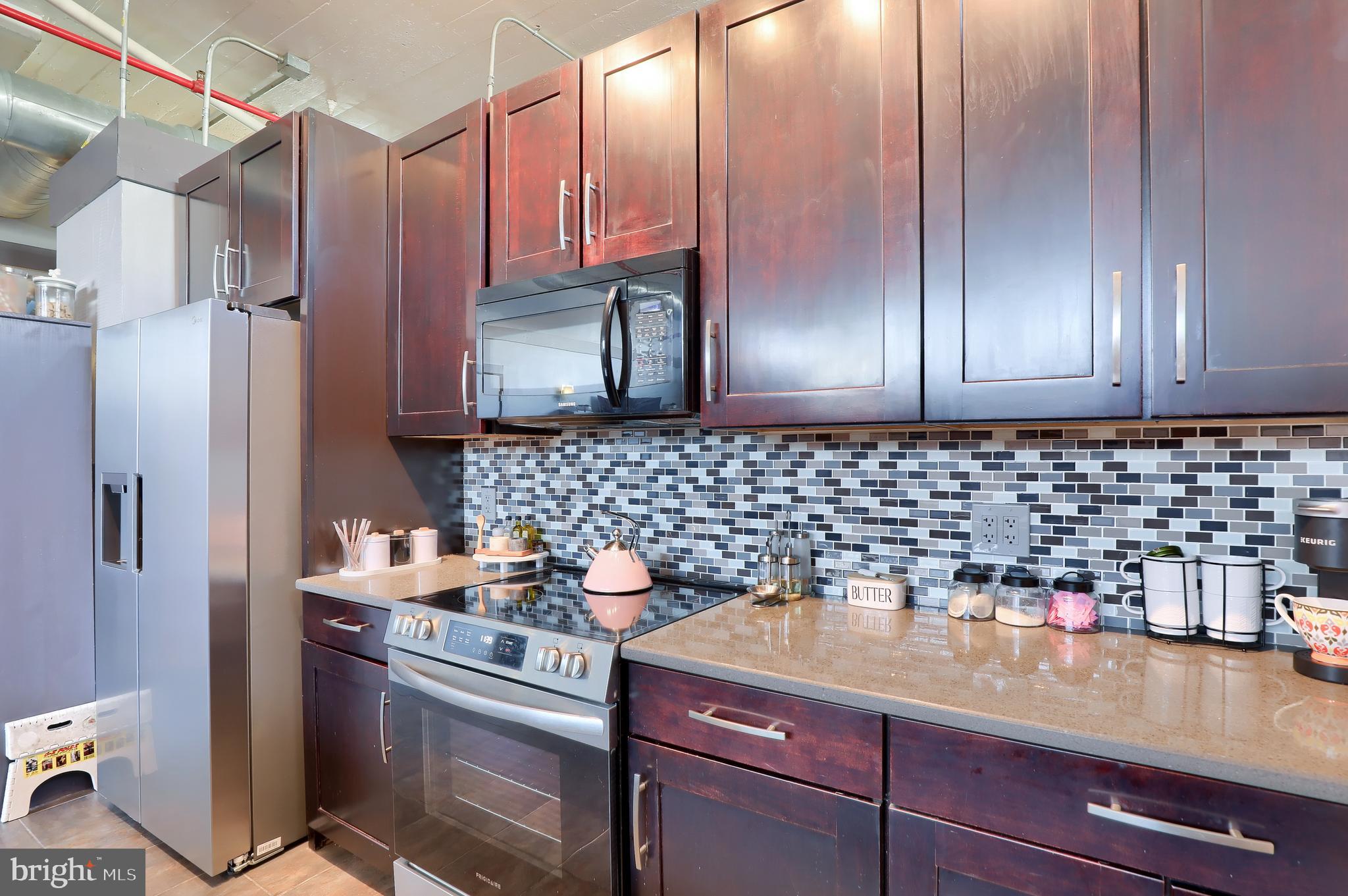 31 South Sterley Street, Unit 101 Shillington, PA 19607 - Photo 18 of 39 a kitchen with stainless steel appliances granite countertop a sink stove and refrigerator