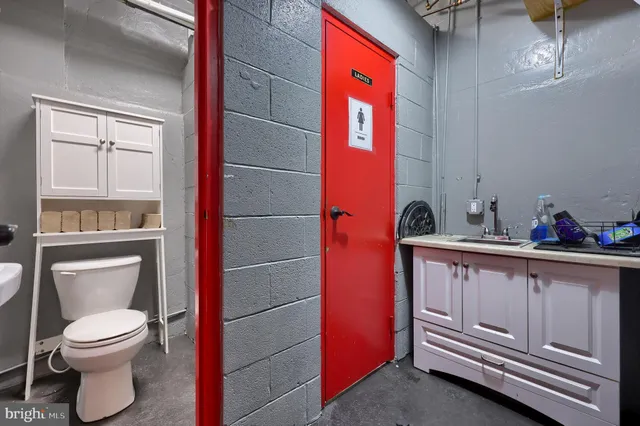 a bathroom with a toilet a sink and a mirror