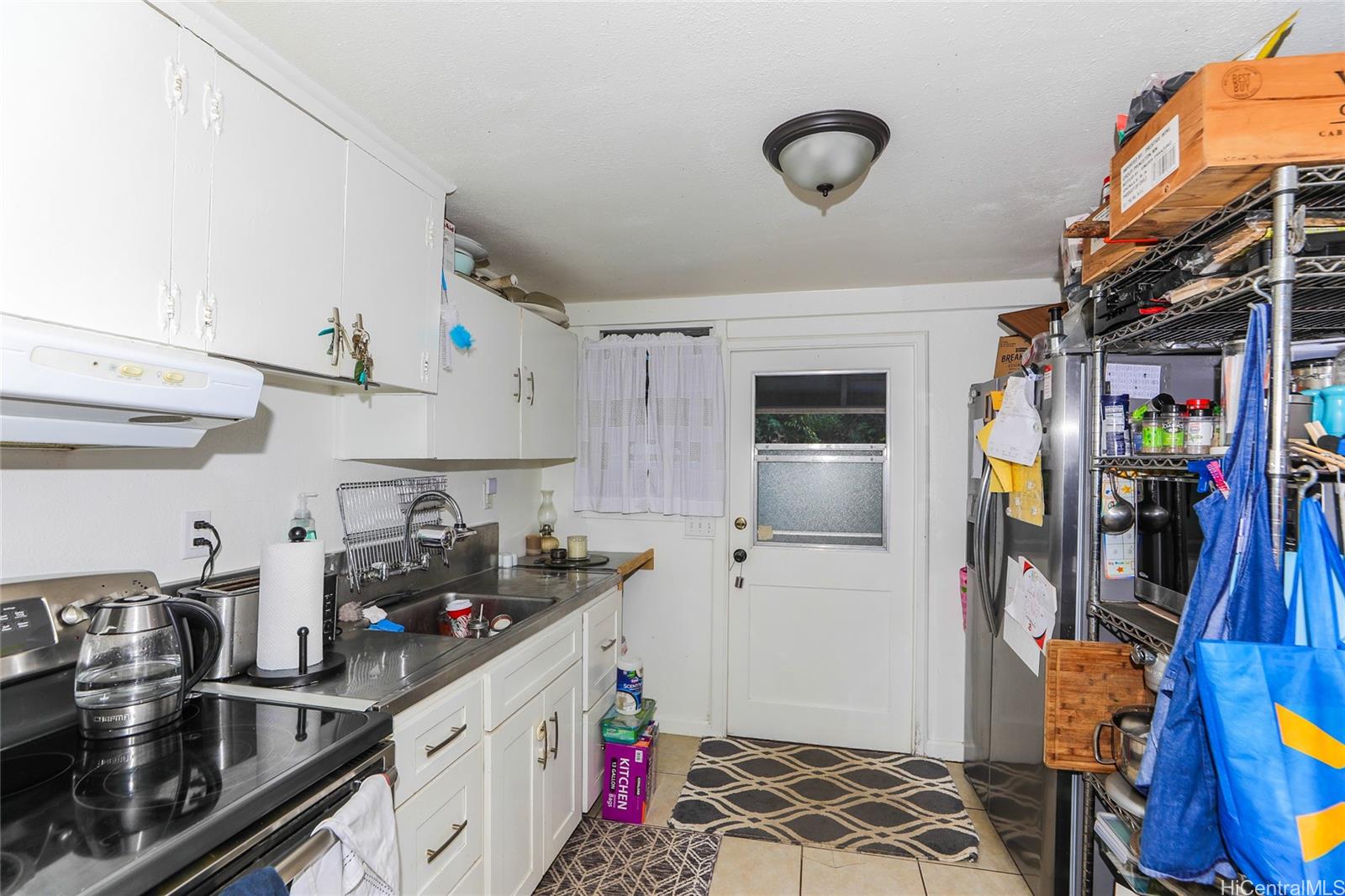 47-270 Ahuimanu Road Kaneohe, HI 96744 - Photo 15 of 25 a kitchen with stainless steel appliances granite countertop a stove and cabinets