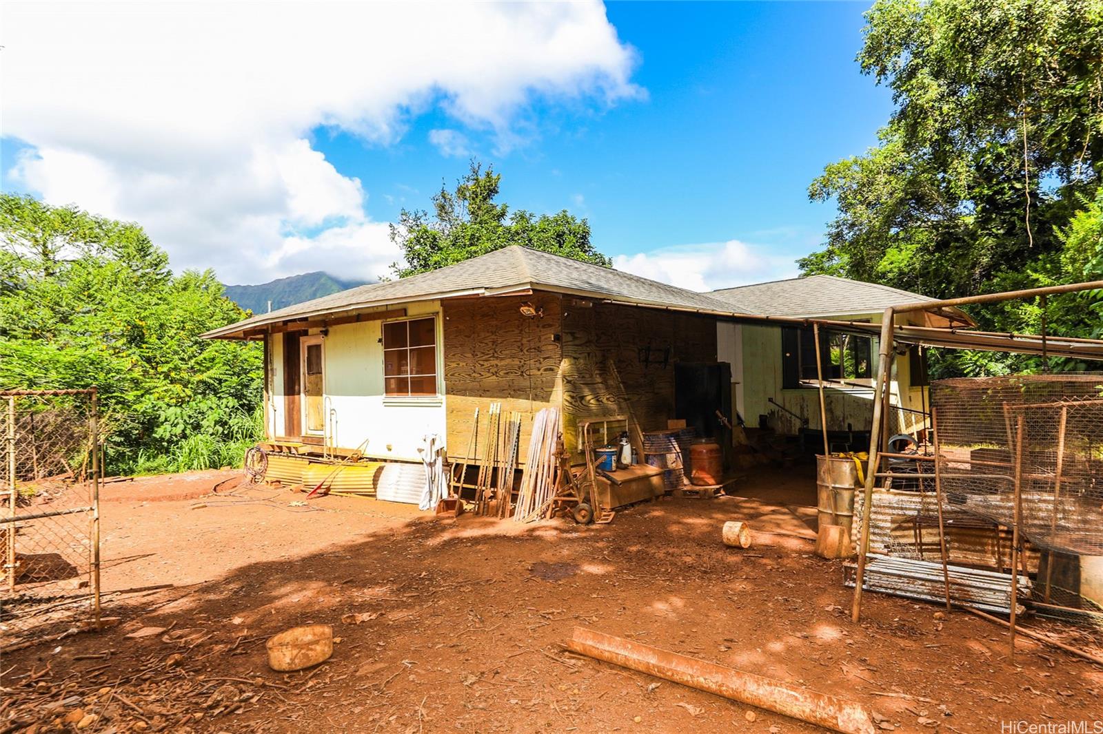 47-270 Ahuimanu Road Kaneohe, HI 96744 - Photo 20 of 25 a patio with a table and chairs under an umbrella