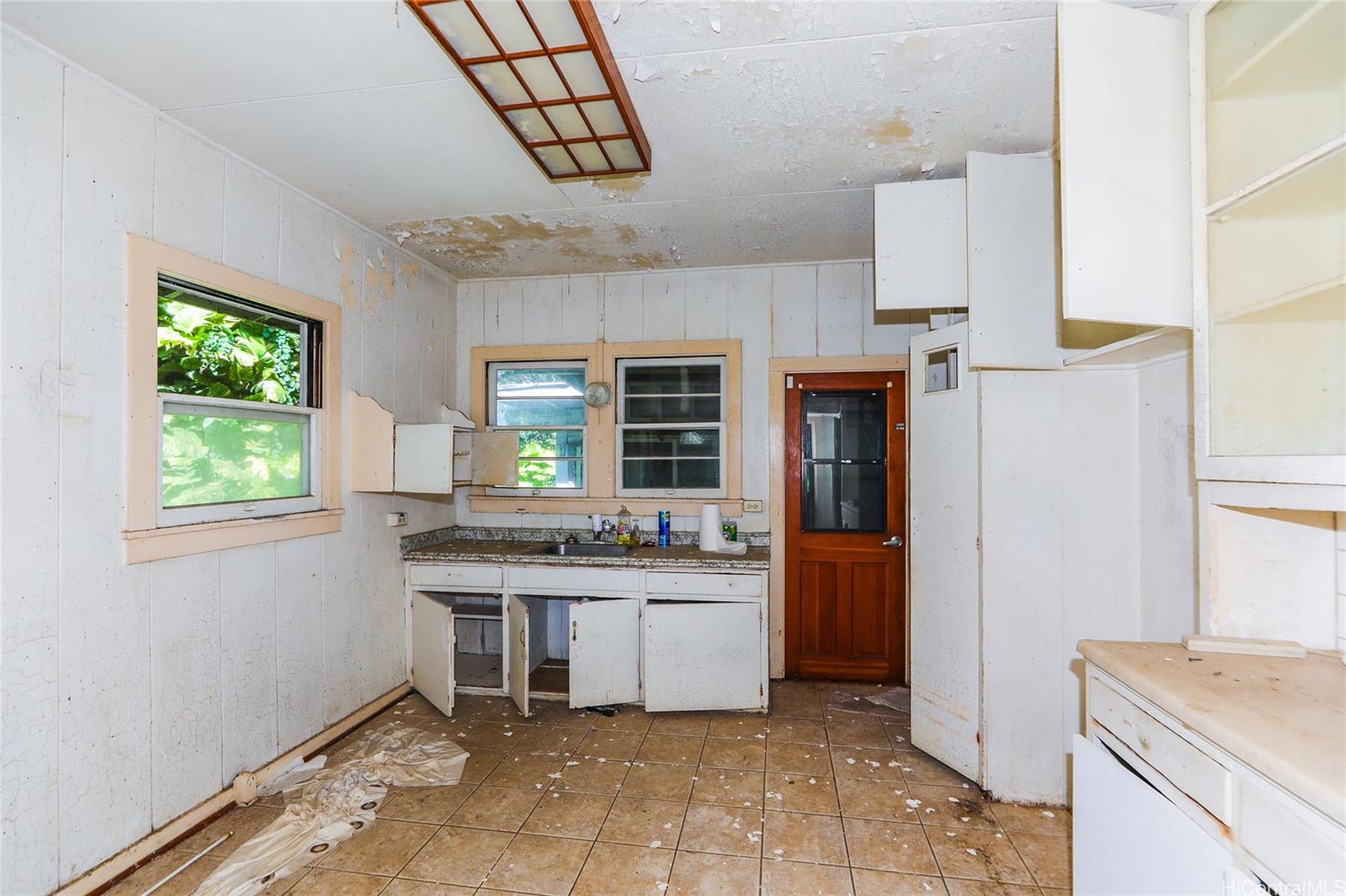 47-270 Ahuimanu Road Kaneohe, HI 96744 - Photo 6 of 25 a kitchen with a sink a stove and cabinets