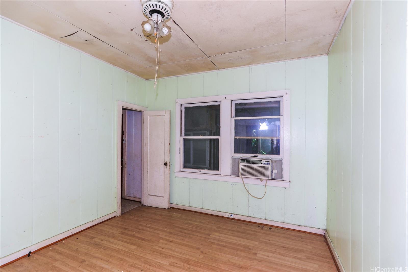 47-270 Ahuimanu Road Kaneohe, HI 96744 - Photo 10 of 25 a room with window and wooden floor