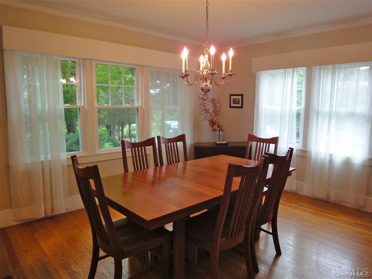 376 Lane Gate Road Cold Spring, NY 10516 - Photo 11 of 23 a view of a dining room with furniture window and wooden floor