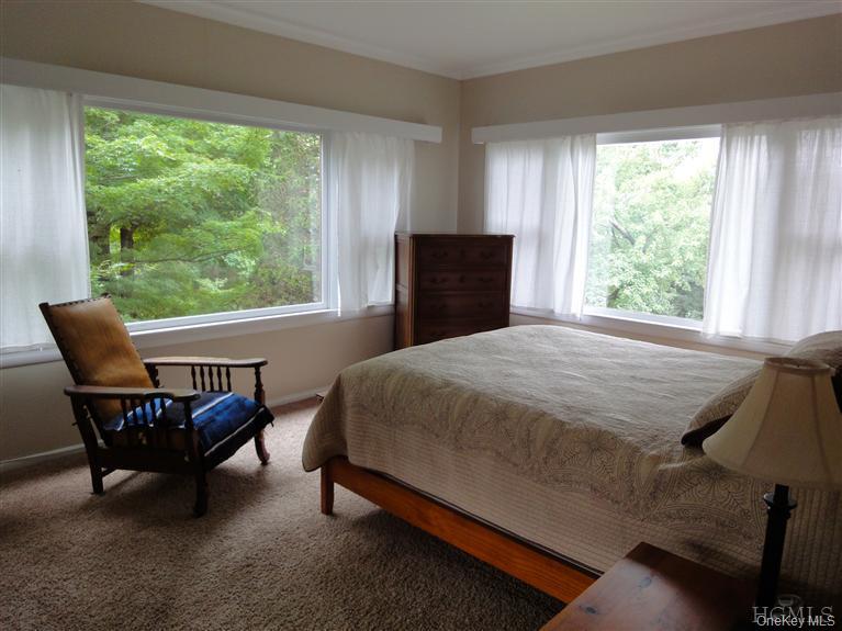 376 Lane Gate Road Cold Spring, NY 10516 - Photo 16 of 23 a bed sitting in a bedroom next to a window