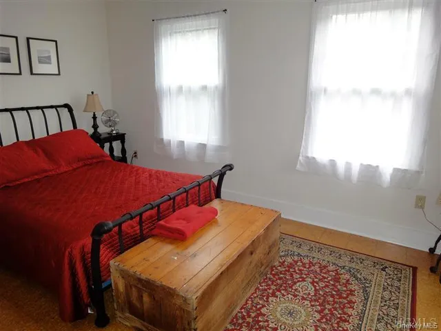 a bedroom with bed and a window
