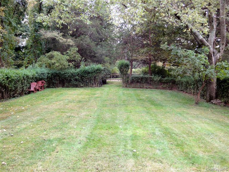 376 Lane Gate Road Cold Spring, NY 10516 - Photo 21 of 23 a view of a garden with a bench