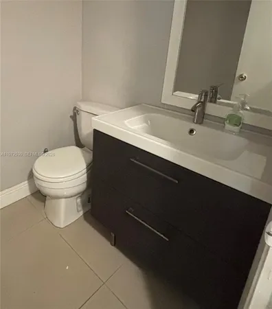 a bathroom with a sink toilet and mirror