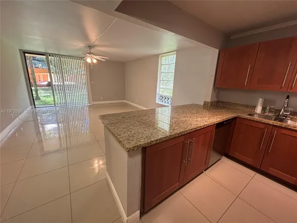 a kitchen with stainless steel appliances granite countertop a sink and cabinets