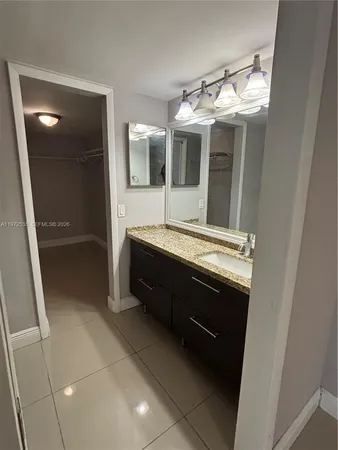 a bathroom with a double vanity sink and mirror
