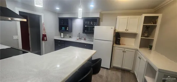 a kitchen with refrigerator and cabinets