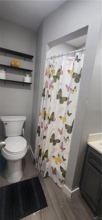 118 Keystone Street Mission, TX 78572 - Photo 10 of 11 a bathroom with a toilet and a shower curtain