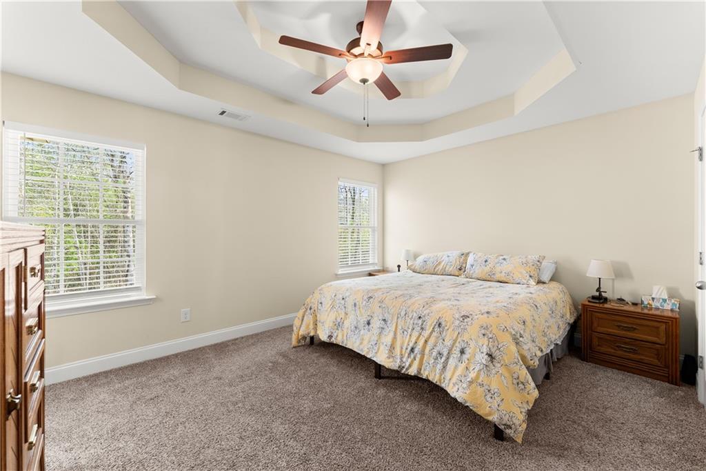 5430 Stepstone Way Gainesville, GA 30506 - Photo 17 of 39 a bedroom with a bed ceiling fan and a window