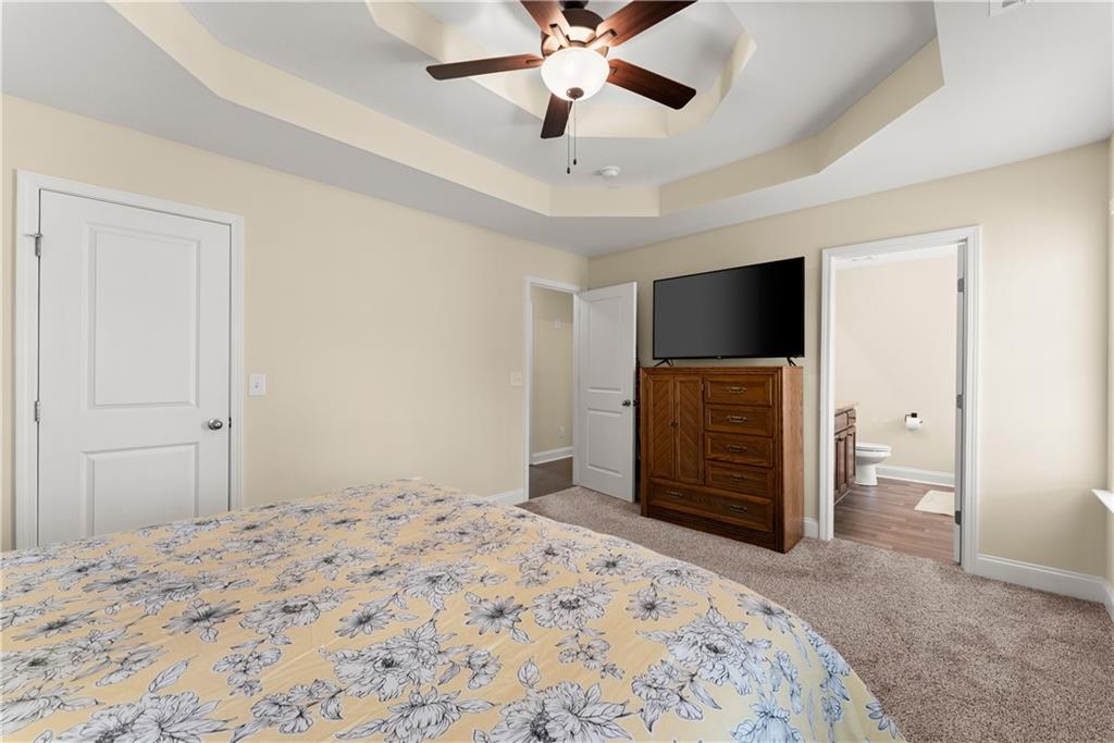 5430 Stepstone Way Gainesville, GA 30506 - Photo 18 of 39 a bedroom with a bed and a flat screen tv