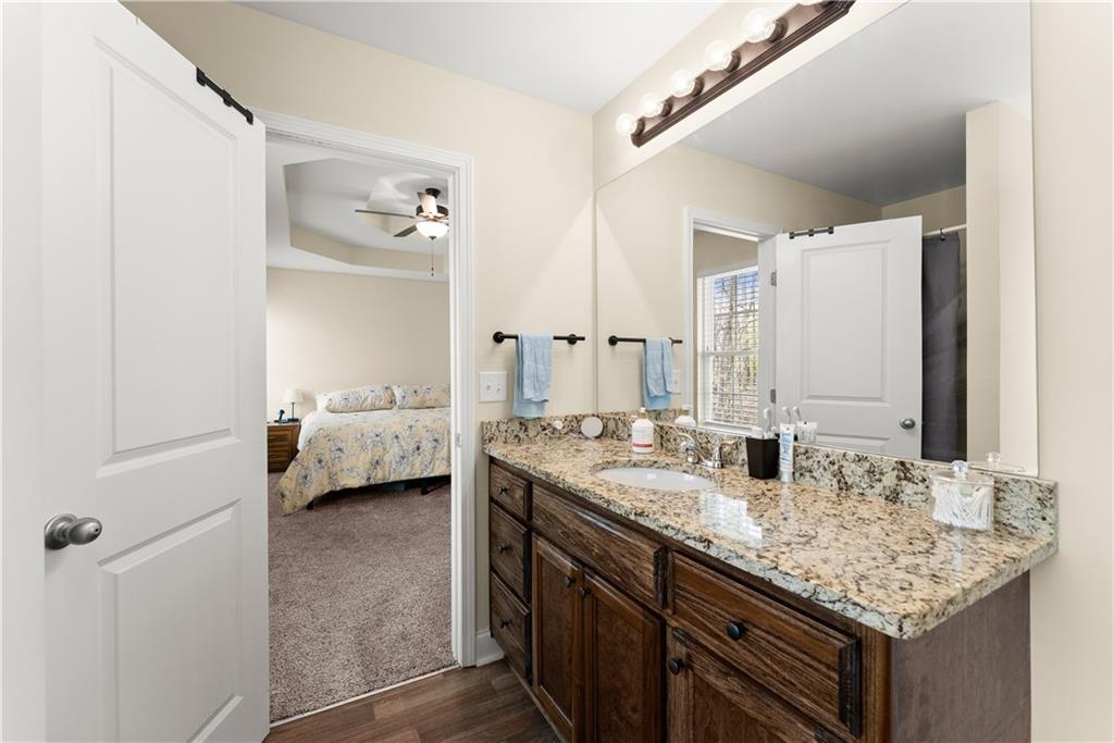 5430 Stepstone Way Gainesville, GA 30506 - Photo 20 of 39 a en suite bathroom with a granite countertop sink and a mirror