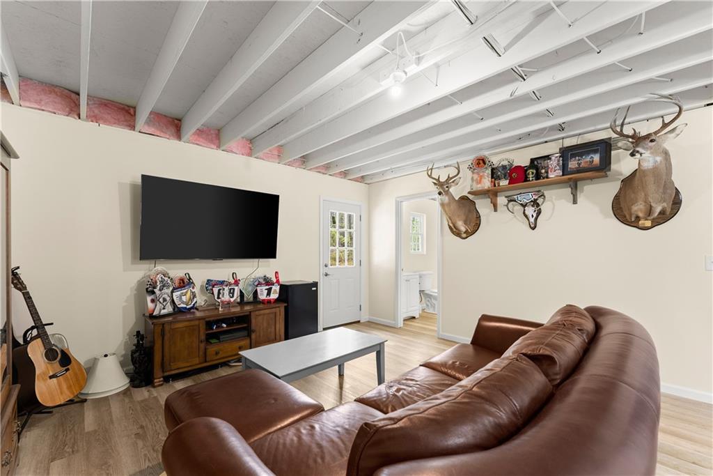 5430 Stepstone Way Gainesville, GA 30506 - Photo 28 of 39 a living room with furniture and a flat screen tv