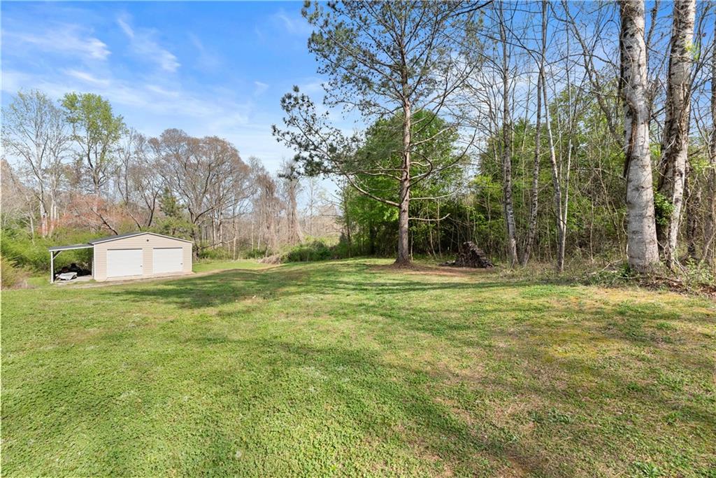 5430 Stepstone Way Gainesville, GA 30506 - Photo 35 of 39 a backyard of a house with lots of green space and fountain