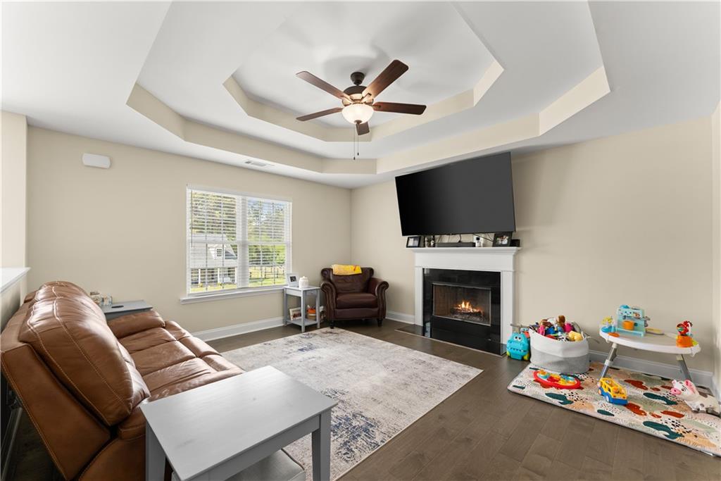 5430 Stepstone Way Gainesville, GA 30506 - Photo 8 of 39 a living room with furniture a flat screen tv and a fireplace