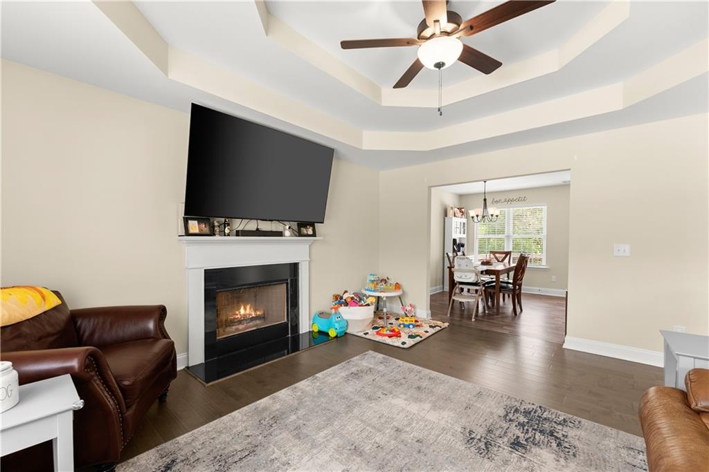 5430 Stepstone Way Gainesville, GA 30506 - Photo 9 of 39 a living room with furniture a fireplace and a flat screen tv