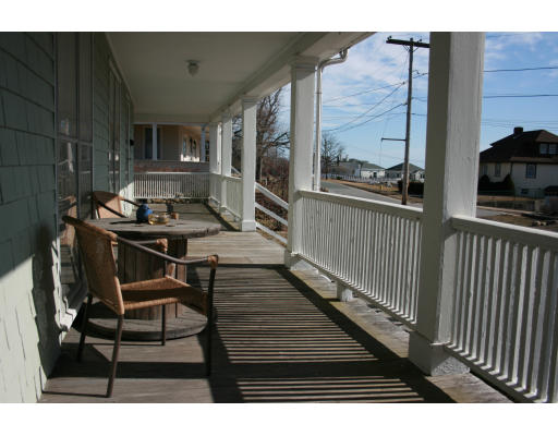 47 Beach Road Gloucester, MA 01930 - Photo 2 of 9 a balcony with table and chairs
