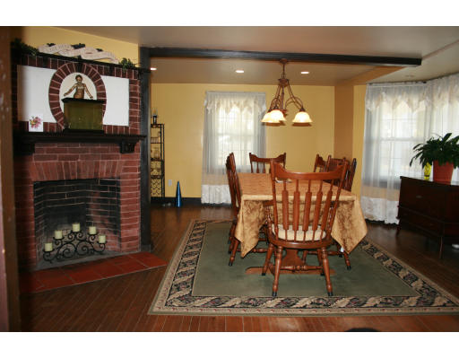 47 Beach Road Gloucester, MA 01930 - Photo 5 of 9 a dining room with furniture and a fireplace