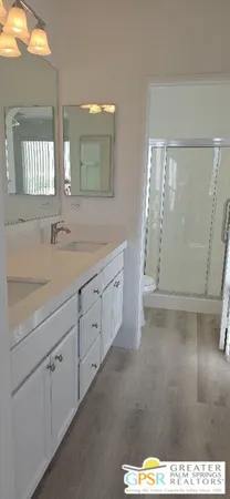 a bathroom with a sink a mirror and a shower