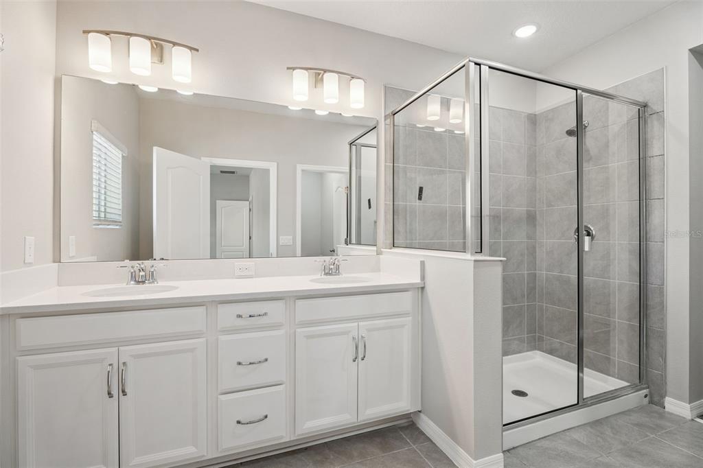 1915 Terrapin Road Ocoee, FL 34761 - Photo 12 of 25 a bathroom with a double vanity sink mirror and shower
