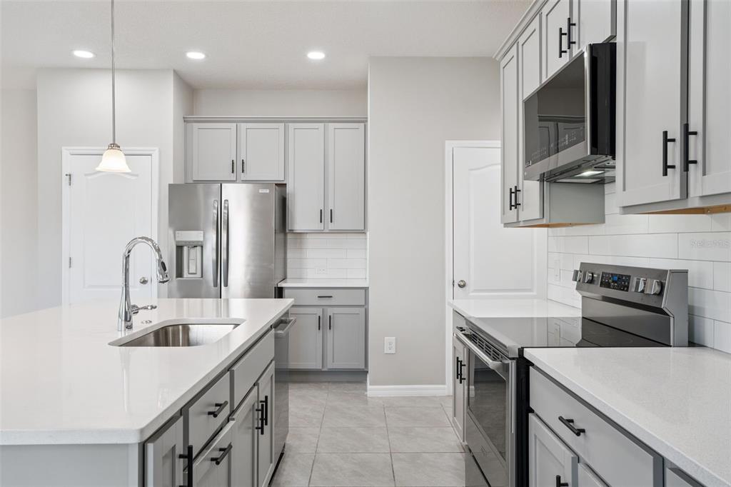1915 Terrapin Road Ocoee, FL 34761 - Photo 5 of 25 a kitchen with refrigerator cabinets and a sink