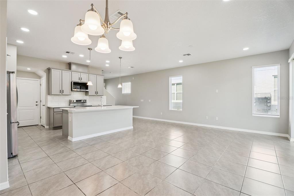 1915 Terrapin Road Ocoee, FL 34761 - Photo 7 of 25 a view of a kitchen with marble kitchen and microwave