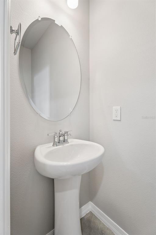 1915 Terrapin Road Ocoee, FL 34761 - Photo 9 of 25 a bathroom with a sink a mirror and vanity