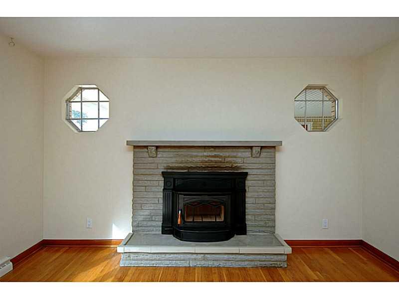 473 Perrymont Road Pittsburgh, PA 15237 - Photo 3 of 25 Other. The stone fireplace in the living room features a wood burning insert. It heats the entire living space and dramatically reduces heating bills. Also note the decorative windows facing the breezeway.