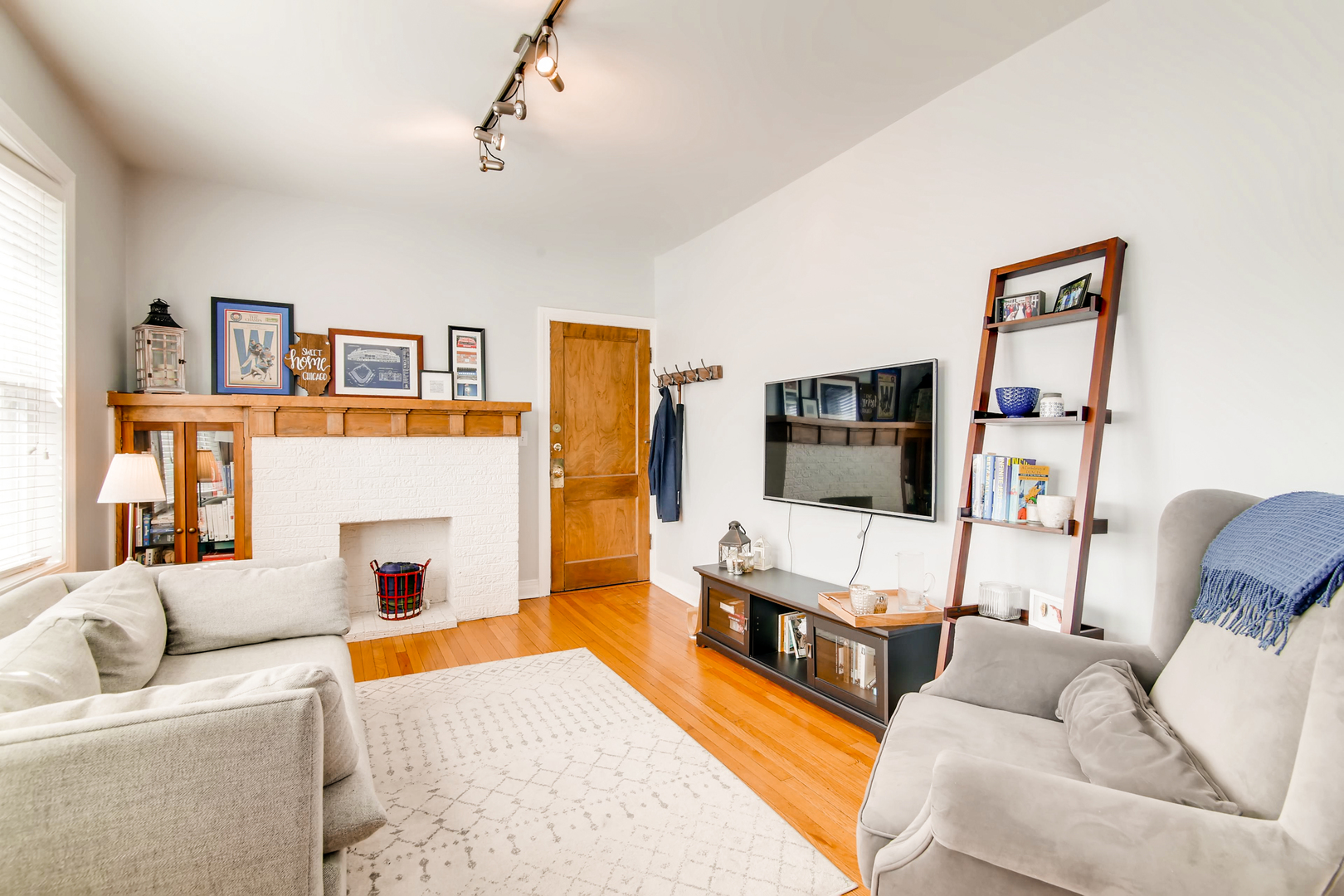5707 North Ridge Avenue, Unit 2 Chicago, IL 60660 - Photo 3 of 11 a living room with furniture and a flat screen tv