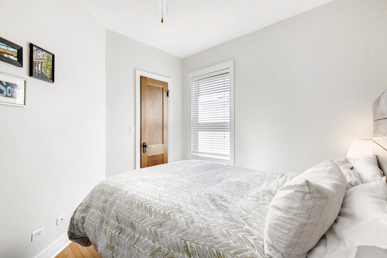 5707 North Ridge Avenue, Unit 2 Chicago, IL 60660 - Photo 9 of 11 a bedroom with a bed and a window