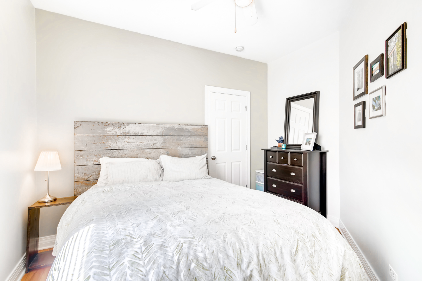5707 North Ridge Avenue, Unit 2 Chicago, IL 60660 - Photo 10 of 11 a bedroom with a bed and wooden floor