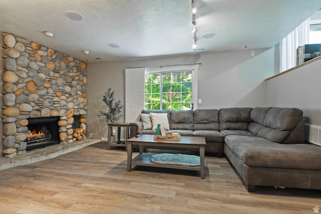 3310 Creek Road Salt Lake City, UT 84121 - Photo 21 of 49 Stone-faced fireplace with a hearth and wood storage niche