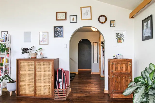 a bedroom with a bed a computer on the desk and a window